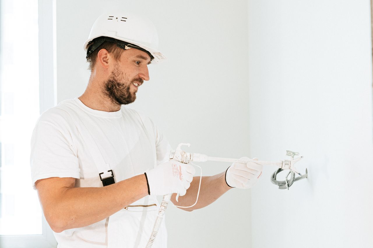 Crafting Captivating Headlines: Your awesome post title goes here Electrician wearing safety gear installing wiring in a new building.