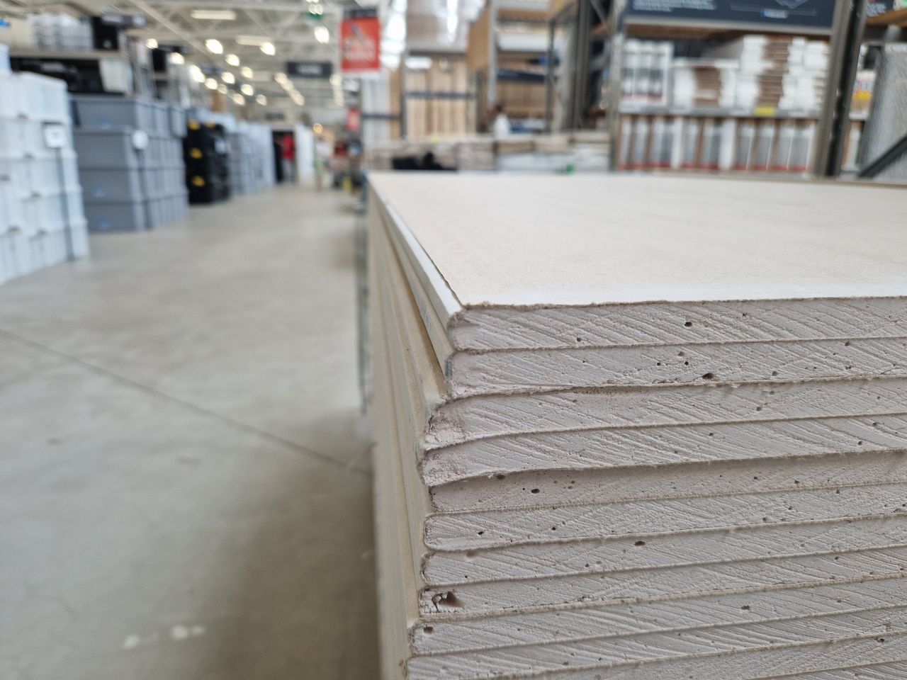 Mastering the First Impression: Your intriguing post title goes here Close-up of drywall sheets stacked in a large warehouse in London.